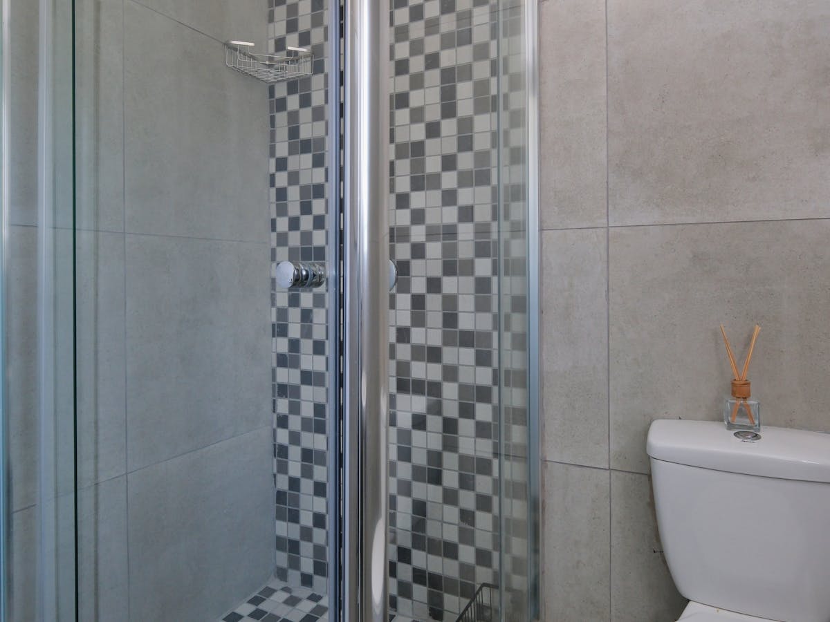 Bagno contemporaneo con gres grande formato e doccia angolare